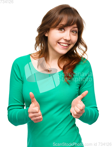 Image of Woman is showing thumb up gesture