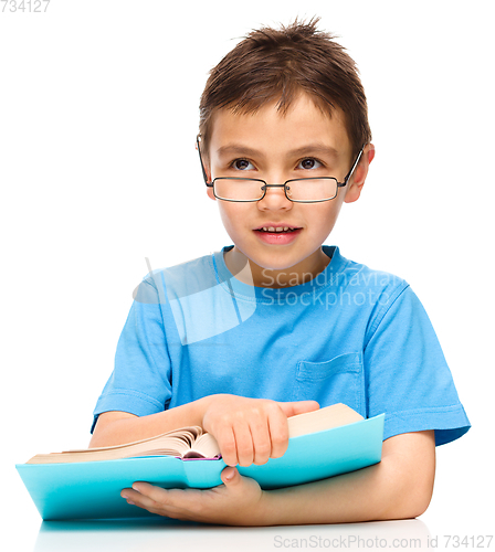 Image of Little boy is reading a book