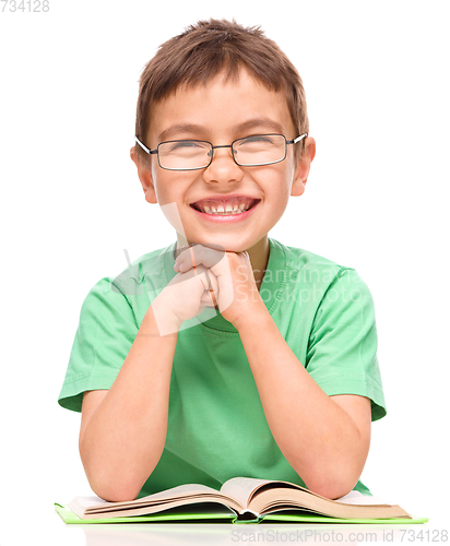 Image of Little boy is reading a book