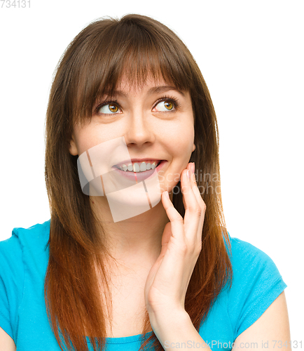 Image of Young woman is touching her cheek with hand