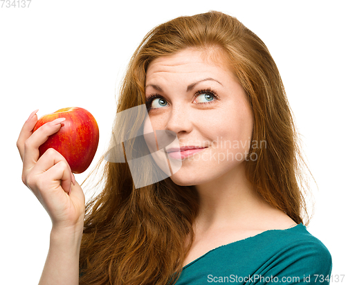 Image of Young happy girl with apple