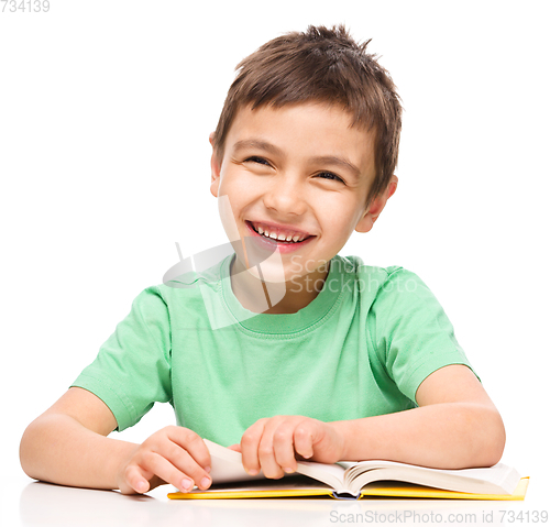 Image of Little boy is reading a book