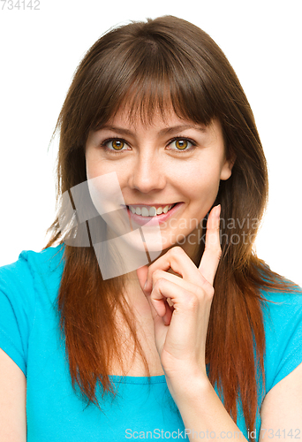 Image of Young woman is supporting her head with hand
