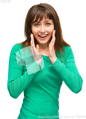 Image of Woman is holding her face in astonishment