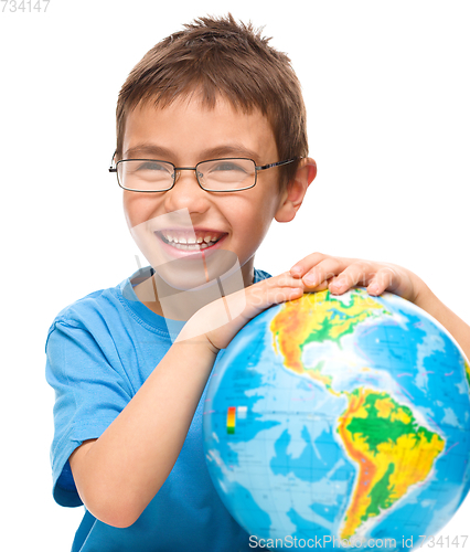 Image of Little boy is holding globe