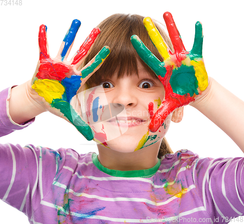 Image of Portrait of a cute girl playing with paints