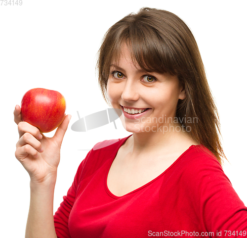 Image of Young happy girl with apple