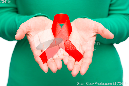 Image of Woman is holding the red awareness ribbon