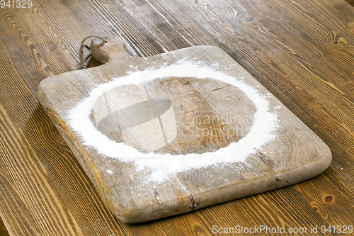 Image of flour on wooden background