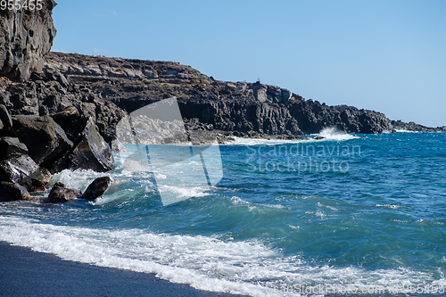 Image of beautiful wild beach with black sand