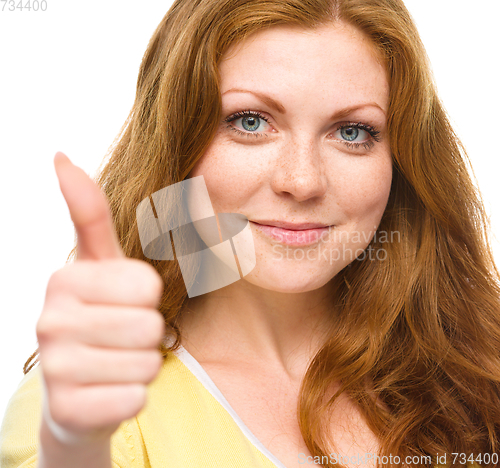 Image of Woman is showing thumb up gesture