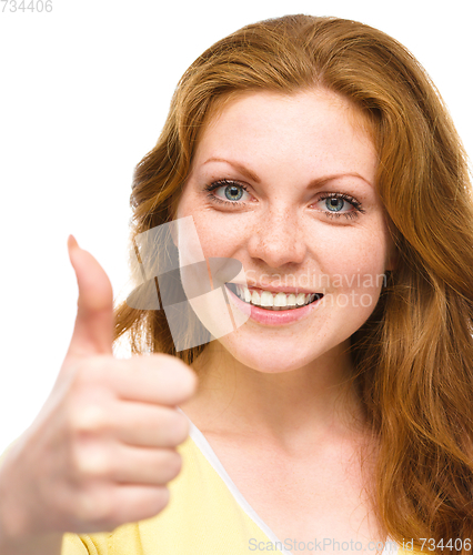 Image of Woman is showing thumb up gesture