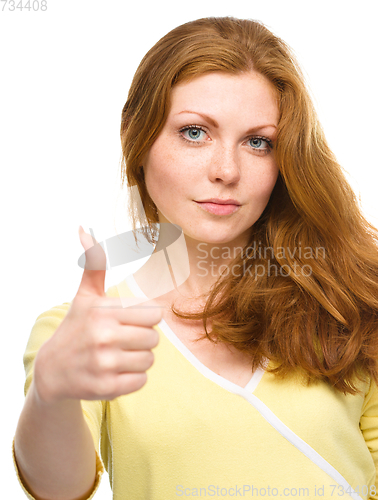 Image of Woman is showing thumb up gesture