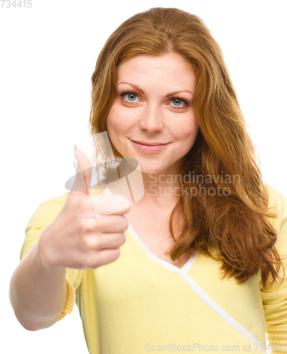 Image of Woman is showing thumb up gesture