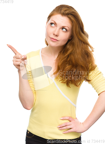 Image of Portrait of a young woman pointing to the left