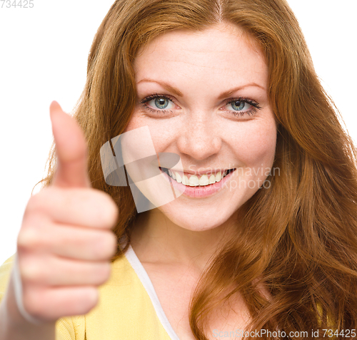 Image of Woman is showing thumb up gesture
