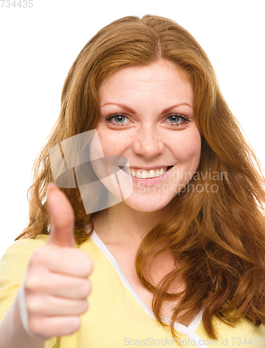 Image of Woman is showing thumb up gesture