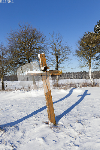 Image of old wooden sagging cross