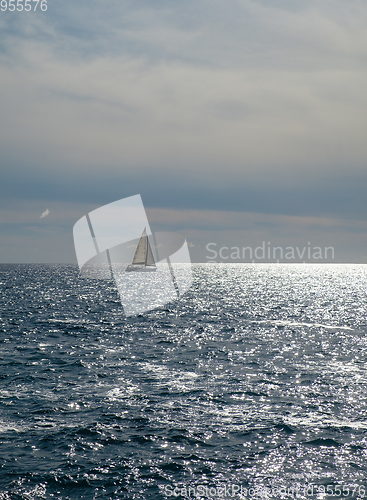 Image of sail boat at horizon line