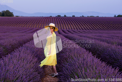 Image of asian woman in yellow dress and hat at lavender field