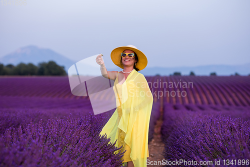 Image of asian woman in yellow dress and hat at lavender field