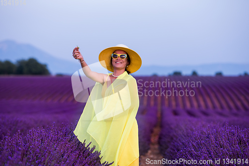 Image of asian woman in yellow dress and hat at lavender field