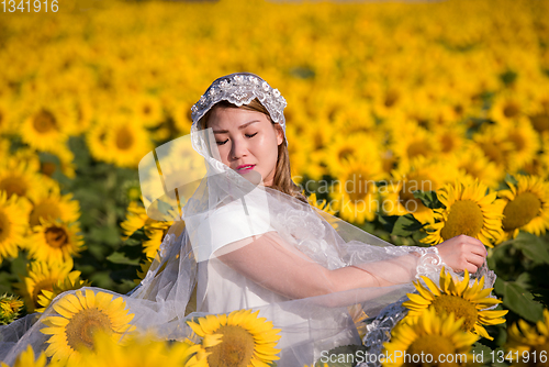 Image of asian woman at sunflower field