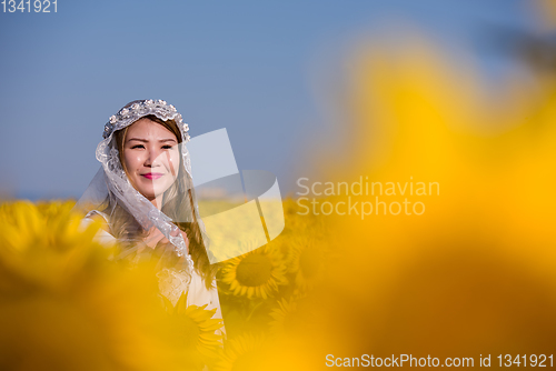 Image of asian woman at sunflower field