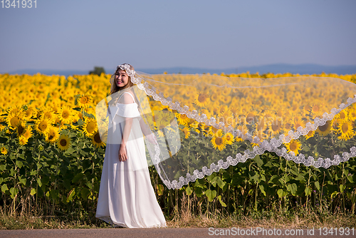 Image of asian woman at sunflower field