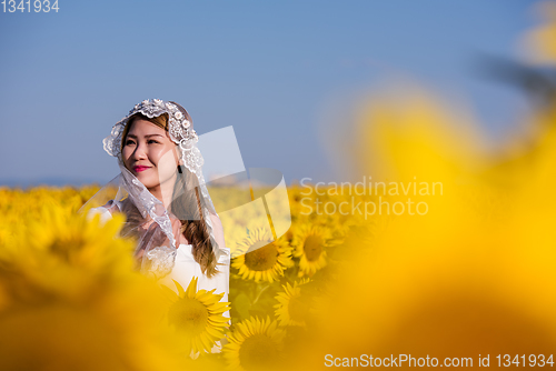 Image of asian woman at sunflower field