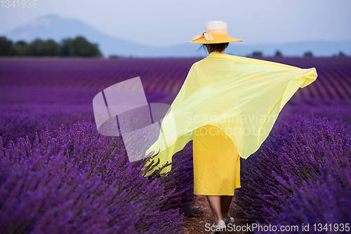 Image of asian woman in yellow dress and hat at lavender field