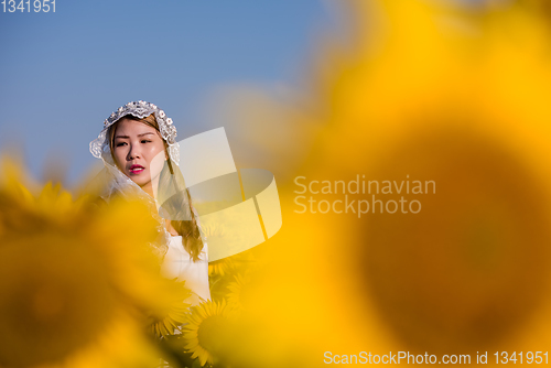 Image of asian woman at sunflower field