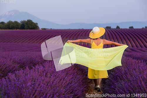 Image of asian woman in yellow dress and hat at lavender field