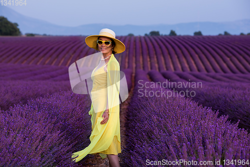 Image of asian woman in yellow dress and hat at lavender field