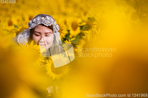 Image of asian woman at sunflower field