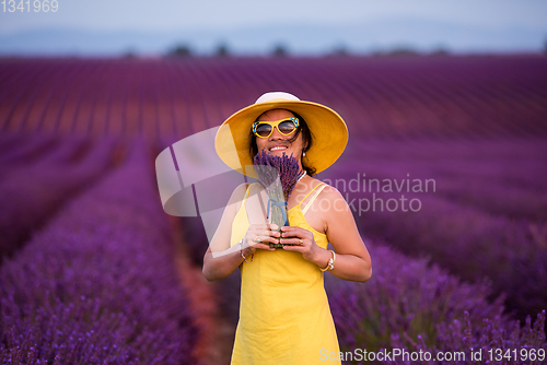 Image of asian woman in yellow dress and hat at lavender field