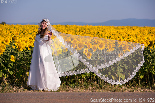 Image of asian woman at sunflower field