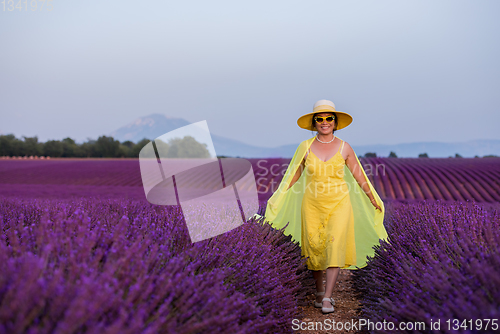 Image of asian woman in yellow dress and hat at lavender field