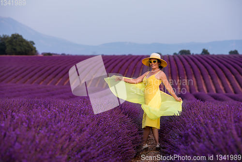 Image of asian woman in yellow dress and hat at lavender field