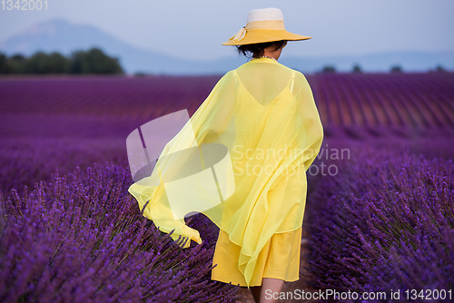 Image of asian woman in yellow dress and hat at lavender field