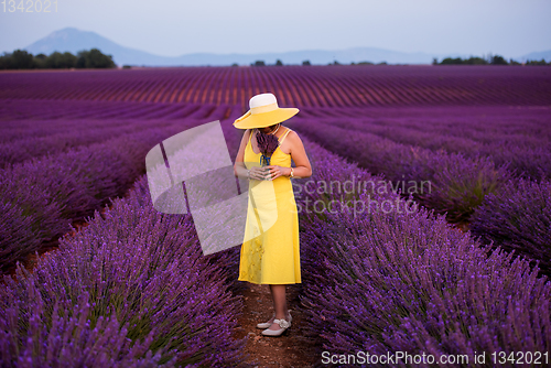 Image of asian woman in yellow dress and hat at lavender field