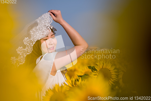 Image of asian woman at sunflower field