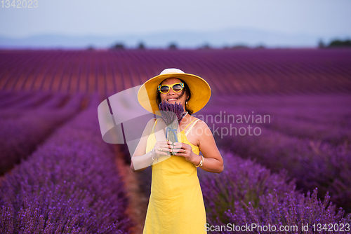Image of asian woman in yellow dress and hat at lavender field