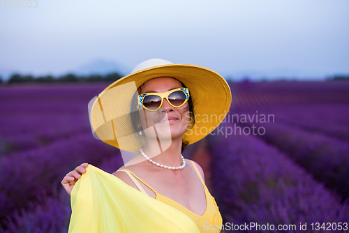 Image of asian woman in yellow dress and hat at lavender field