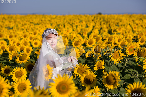 Image of asian woman at sunflower field