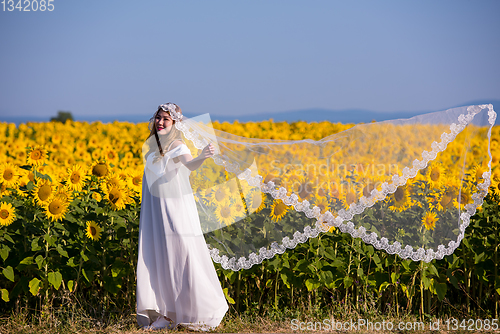 Image of asian woman at sunflower field