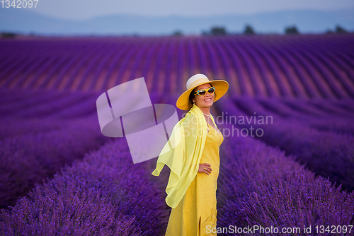 Image of asian woman in yellow dress and hat at lavender field