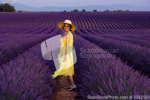 Image of asian woman in yellow dress and hat at lavender field