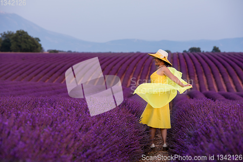 Image of asian woman in yellow dress and hat at lavender field