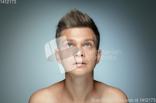 Image of Portrait of shirtless young man isolated on grey studio background
